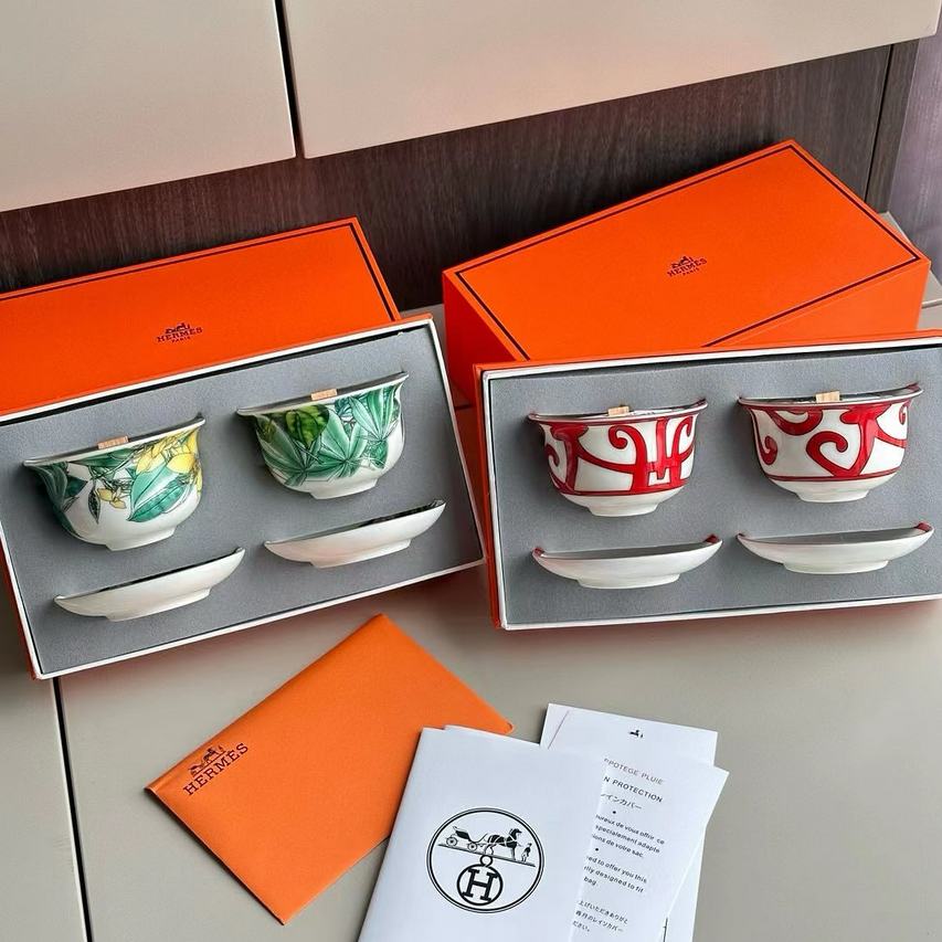 Hermès scented candles sets, including ceramic cups and small base plates. - Hermes Candles | Aleppo Gift UAE