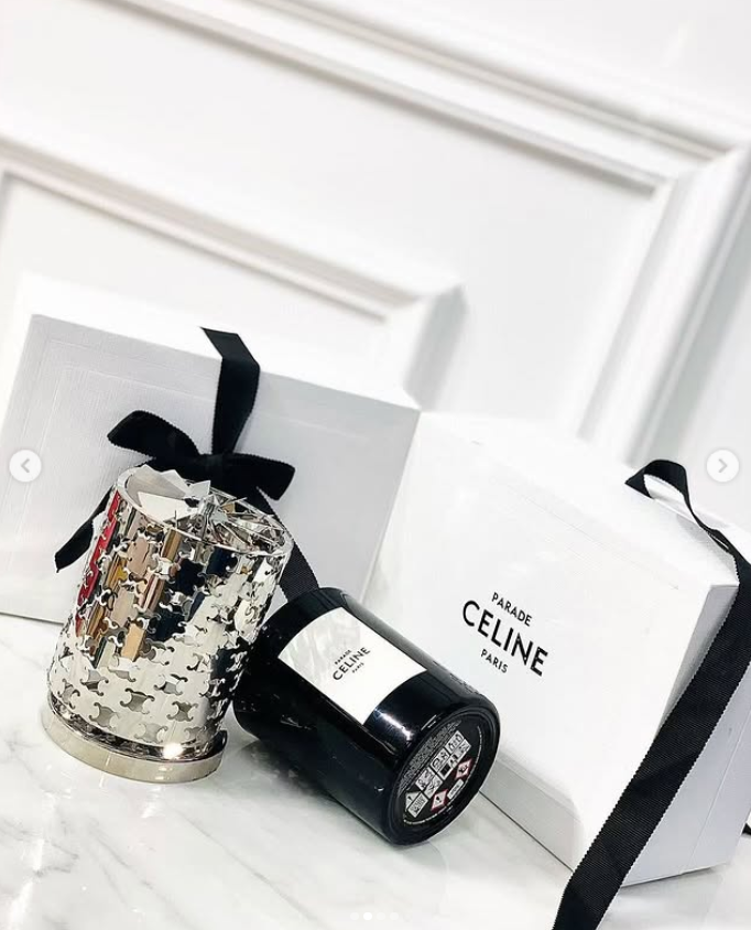 Celine Haute Parfumerie Silence Blanc scented candle gift set. The set features a 240g perfumed candle housed in a black glass container with a black wax wick. It includes a metallic cut-out candle holder designed to mimic the lines of a Celine perfume bo - Image 2 of 3